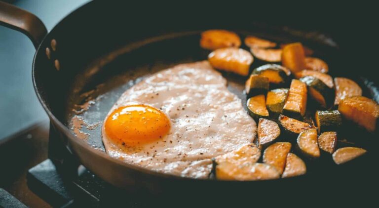 Fried egg and potatoes in a frying pan