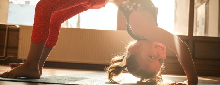 Young girl doing a plank on the floor