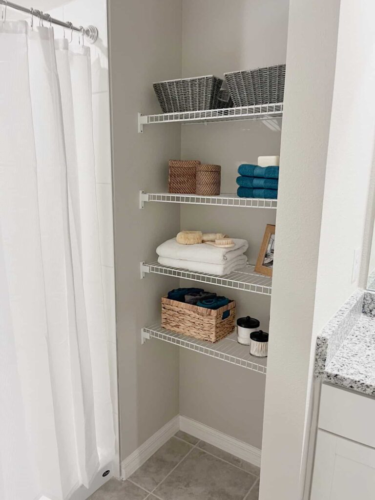 Bathroom closet with towels and other bathroom amenities