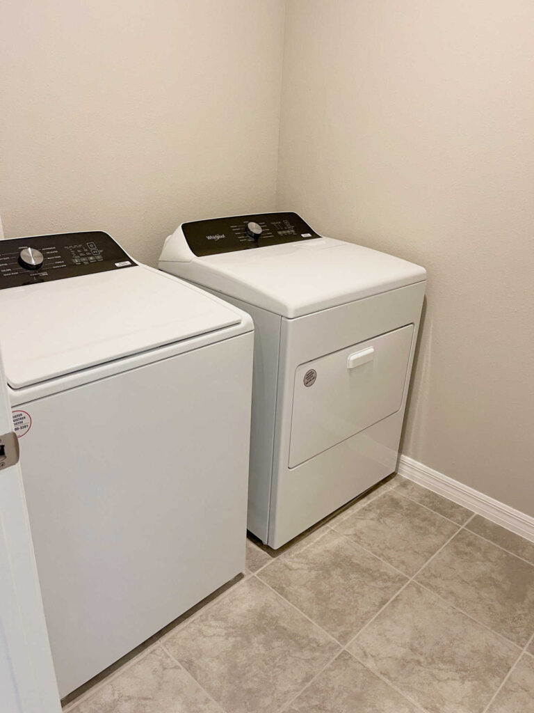 Laundry room with top-loading washer and front-loading dryer