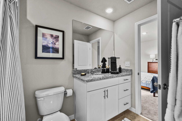 Single bathroom with sink, toilet, and bathtub/shower curtain