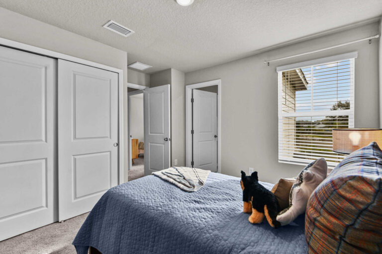 Single bedroom with twin-size bed and sliding door closet